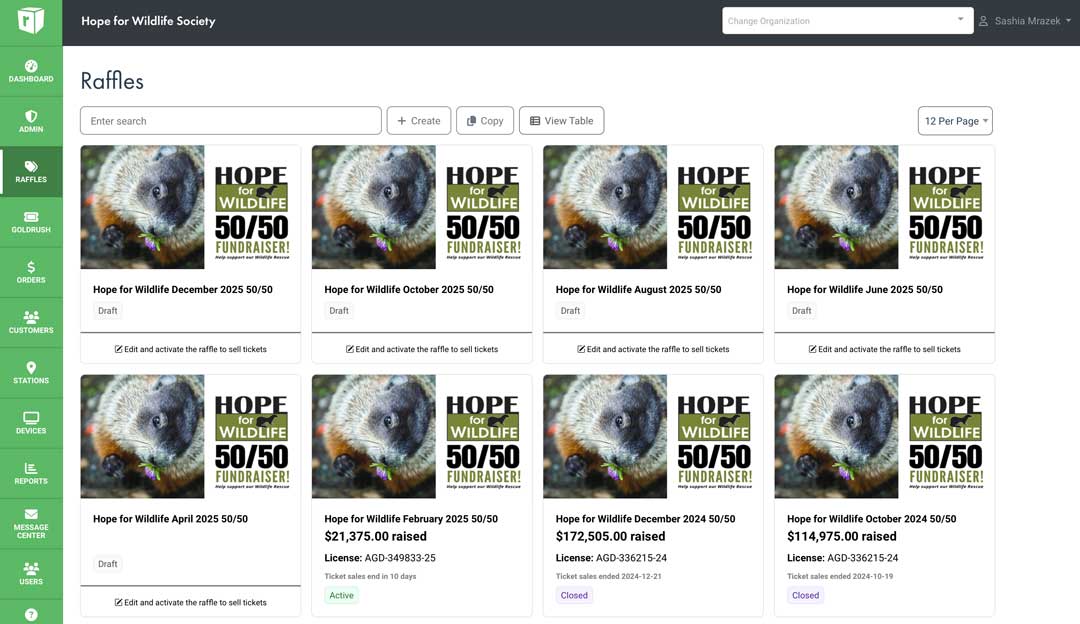 Hope for Wildlife Society Rafflebox admin dashboard showing multiple 50/50 fundraiser campaigns with wombat images. The dashboard displays several raffles from different months in 2024-2025, with some showing amounts raised (over $100,000) and status indicators (Active/Closed).