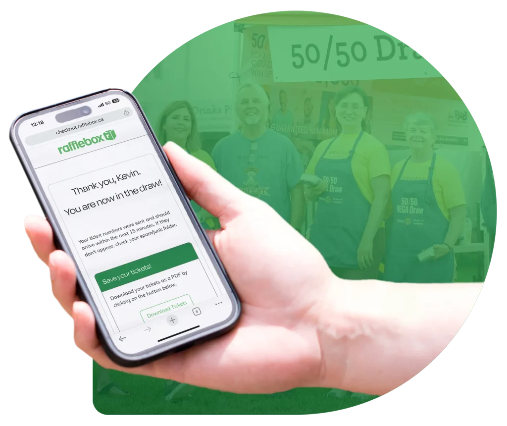 Hand holding cellphone with the Rafflebox app open saying: "Thank you, Kevin. You are now in the draw!"